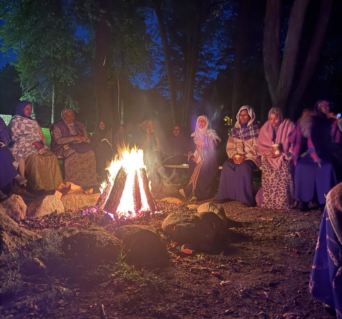 Sisters around a campfire at a Jannah Institute retreat